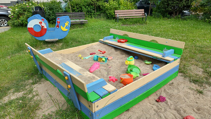 Close-up of suspended wooden playground bridge with ropes and chains. Child's foot on one plank. Safe adventure equipment for kids’ motor skills development