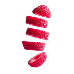 Vibrant red raspberry slices levitating against black background