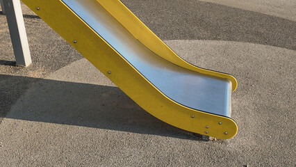 Close-up of suspended wooden playground bridge with ropes and chains. Child's foot on one plank. Safe adventure equipment for kids’ motor skills development