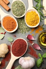 Different spices on grey table, flat lay
