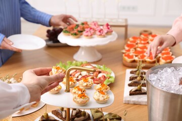 People with different appetizers at buffet, closeup