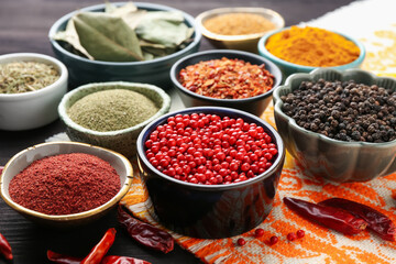 Different aromatic spices on wooden table, closeup