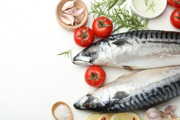 Seafood delicacies. Fresh raw mackerels and spices on white table, flat lay. Space for text