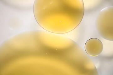 Abstract Yellow Oil Drops on Soft Background Creating Gentle Atmosphere