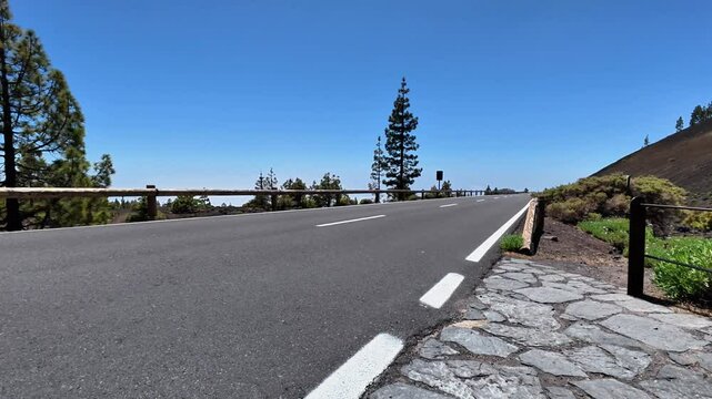 Imagine a breathtakingly picturesque view of a winding mountain road intertwined with trees and stunning landscapes