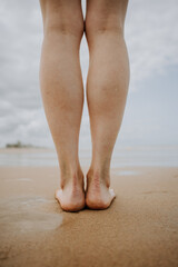 A girl is walking on the beach.