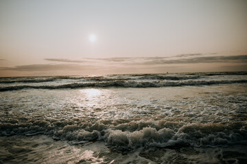 Stormy sea at sunset waves