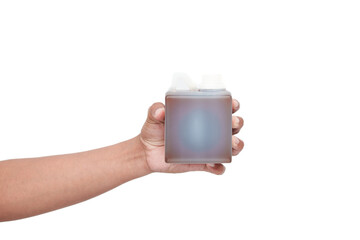 Hand Holding a Bottle of Brown Liquid