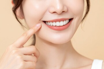Fototapeta premium Japanese woman with perfect teeth is smiling and pointing at her mouth, showcasing her bright smile and healthy teeth. image conveys confidence and happiness