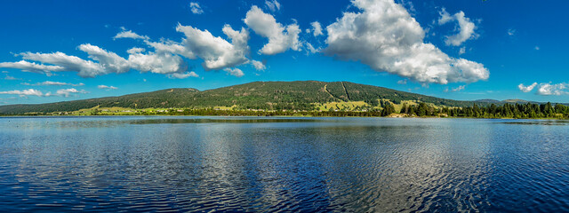 Panoramic Landscape of Lac des Rousses in Summer. Jura Mountains, France.