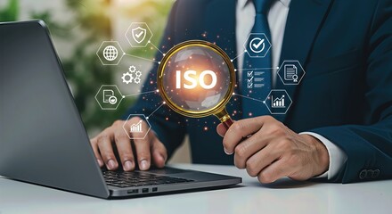 A businessman examines the iso certification with a magnifying glass over a digital interface connected to a laptop