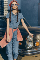 Lifestyle woman in modern boho-western denim street style with braided hair and sunglasses, wrapped...