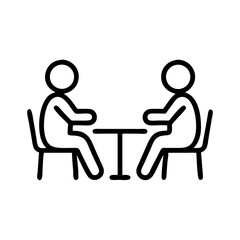 Two people sitting at a table in a caf&eacute; discussing ideas  