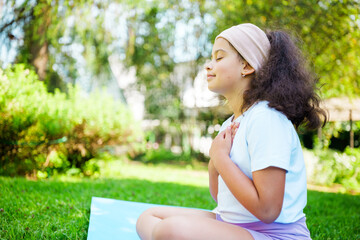 Relaxing moment of mindfulness in a lush garden with a young girl meditating peacefully