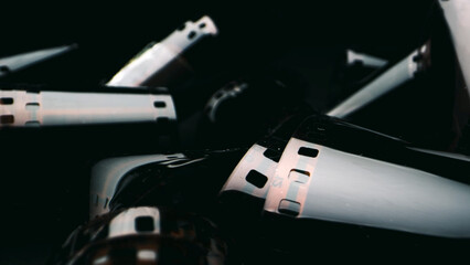An old twisted color film lies on a dark background, symbolizing memories on the film. The film...