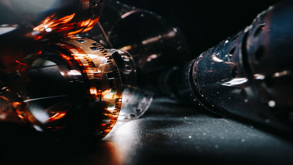 The film creates a vintage and nostalgic feel. Close-up of a roll of film showing the perforated...