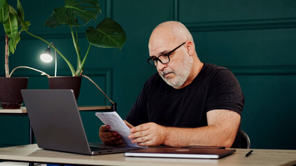 A professional male programmer brainstorms in a modern office. Perfect for themes of innovation,...