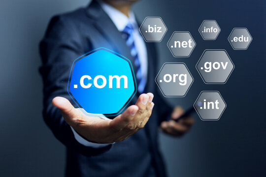 Domain name concept with businessman holding dot com to be a top level of website domain in business webpage