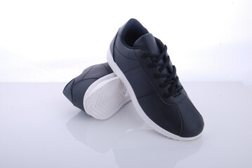 New stylish black sneakers with white soles set on a clean surface showcasing modern design and...