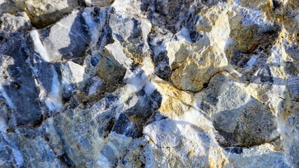 close-up of a mountain stone in grey tones and white pointed formations