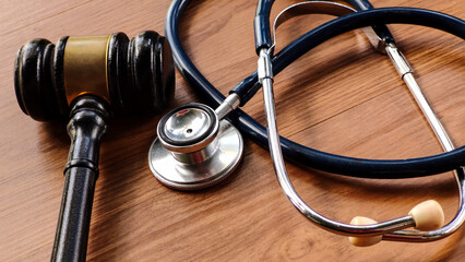 Gavel and Stethoscope on Wooden Table