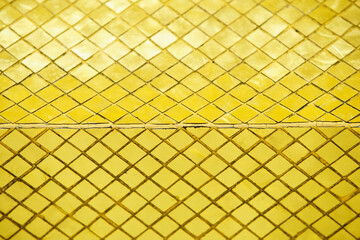 Shimmering Golden Mosaic Tiles in Geometric Pattern Design