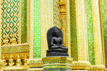 Serene Buddha Statue Surrounded by Intricate Golden Temple Design