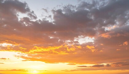 Fototapeta premium A golden sunset sky filled with clouds