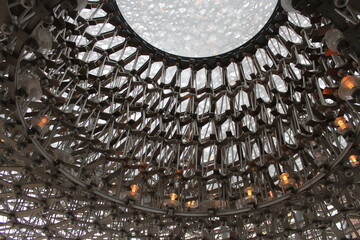 Intricate Geometric Ceiling with Glowing Lights and Reflective Surface Design