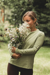 a bouquet of meadow flowers in female hands