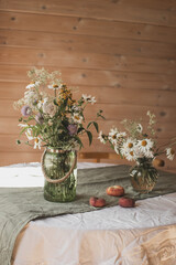 summer still life, bouquet of wild flowers in a vase on the table, meadow flowers