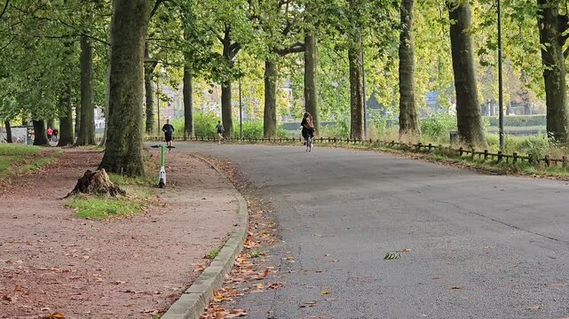 Lille, France - 15 October 2024 - People walking and jogging on the path in Parc de la Citadelle, Lille