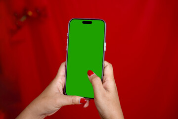 Mobile phone, green screen on red background.