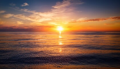vibrant orange sunset over gentle ocean waters reflecting sunlight in serene scene