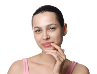 Young woman with lip balm on white background