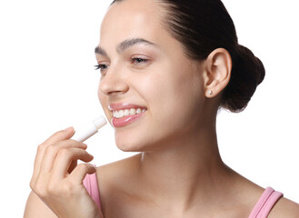 Young woman with lip balm on white background