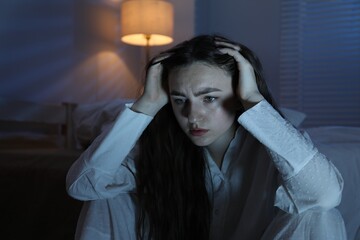 Frustrated woman suffering from insomnia at home