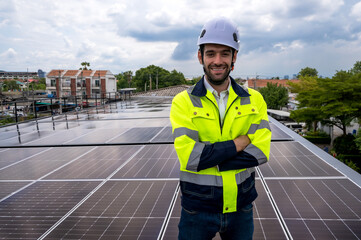 Portrait smiling photovoltaic engineer man working with solar panels on roof