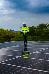 Black solar engineer man working with solar panels on roof