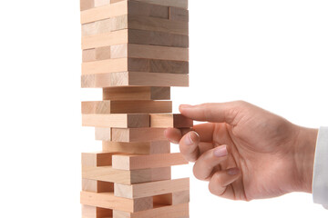 Lviv, Ukraine - December 05, 2023: Woman playing Jenga on white background, closeup