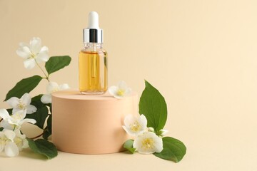 Cosmetic product and jasmine flowers on beige background. Space for text
