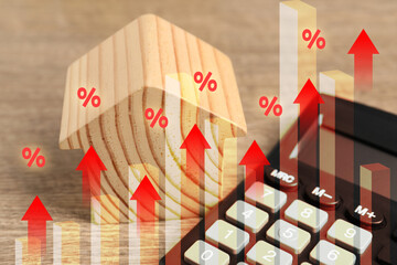 Increase in real estate value. House model and calculator on table. Growing price represented by...