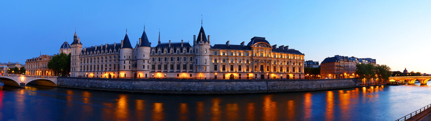 Beautiful view of Seine and Conciergerie at night in Paris, France
