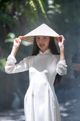 Young Vietnamese woman in white dress in summer
