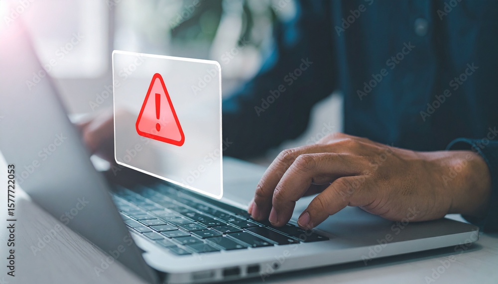 Aufkleber person working on laptop with warning sign appearing on the screen. the image shows a close up of ha