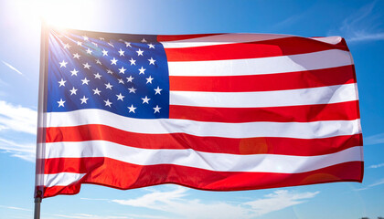 A close-up shot of the flag of United States waving with a sunny sky in background. The image represents national pride and patriotism