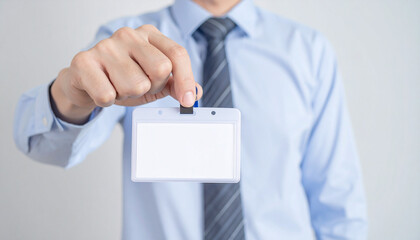 A man holding an empty name tag, showcasing a professional identity