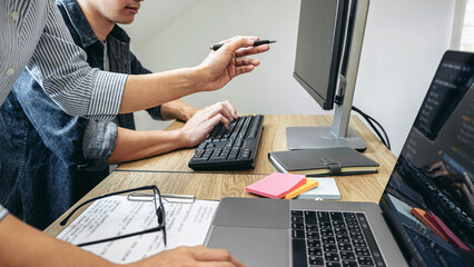 Writing codes and typing data code technology, Programmer team working on web site project in a...