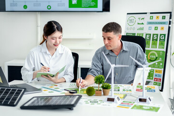 Business professionals collaborate on ESG strategy green initiatives and sustainable energy solutions to achieve carbon reduction goals