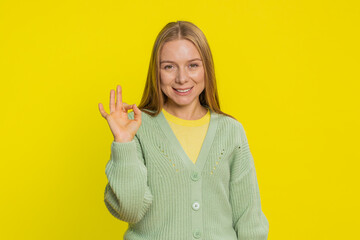Okay. Happy joyful Caucasian middle-aged woman looking approvingly at camera showing ok gesture,...
